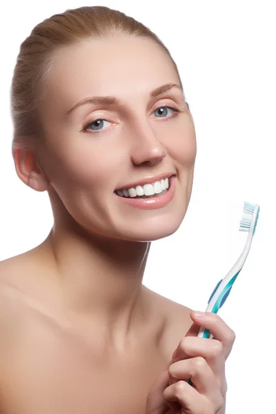 Beautiful woman with toothbrush. Dental care background. Closeup on young woman showing toothbrush. Beautiful young woman holding a toothbrush in hand — Stock Photo, Image