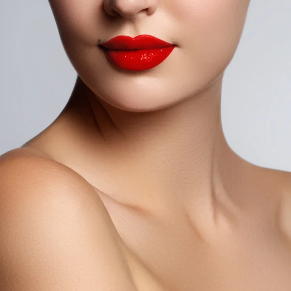 Beautiful young model with red lips and french manicure. Part of female face with red lips. Close-up shot of woman lips with glossy red lipstick. Glamour red lips make-up, purity skin. Retro beauty style — Stok fotoğraf