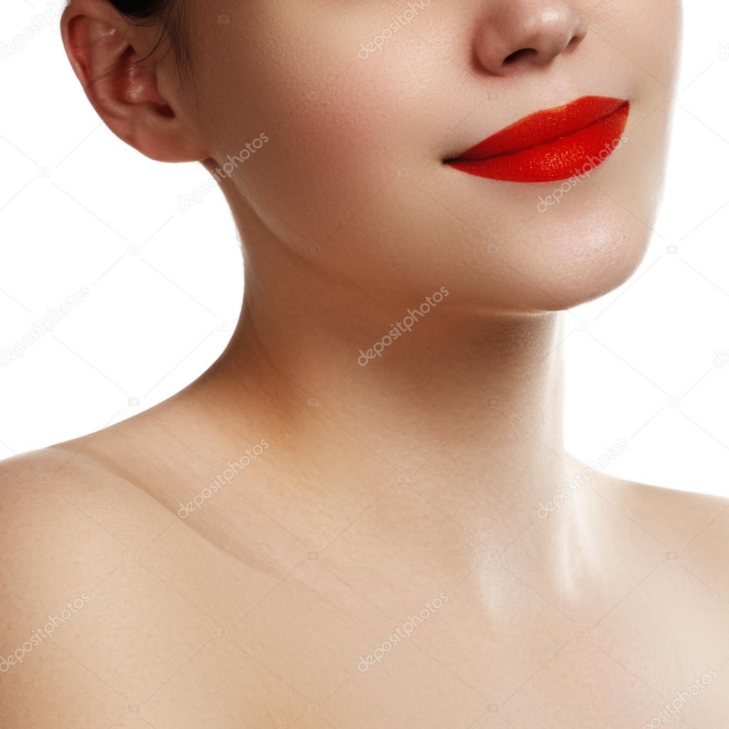 Close-up of woman's lips with bright fashion red makeup. Macro bloody lipstick make-up