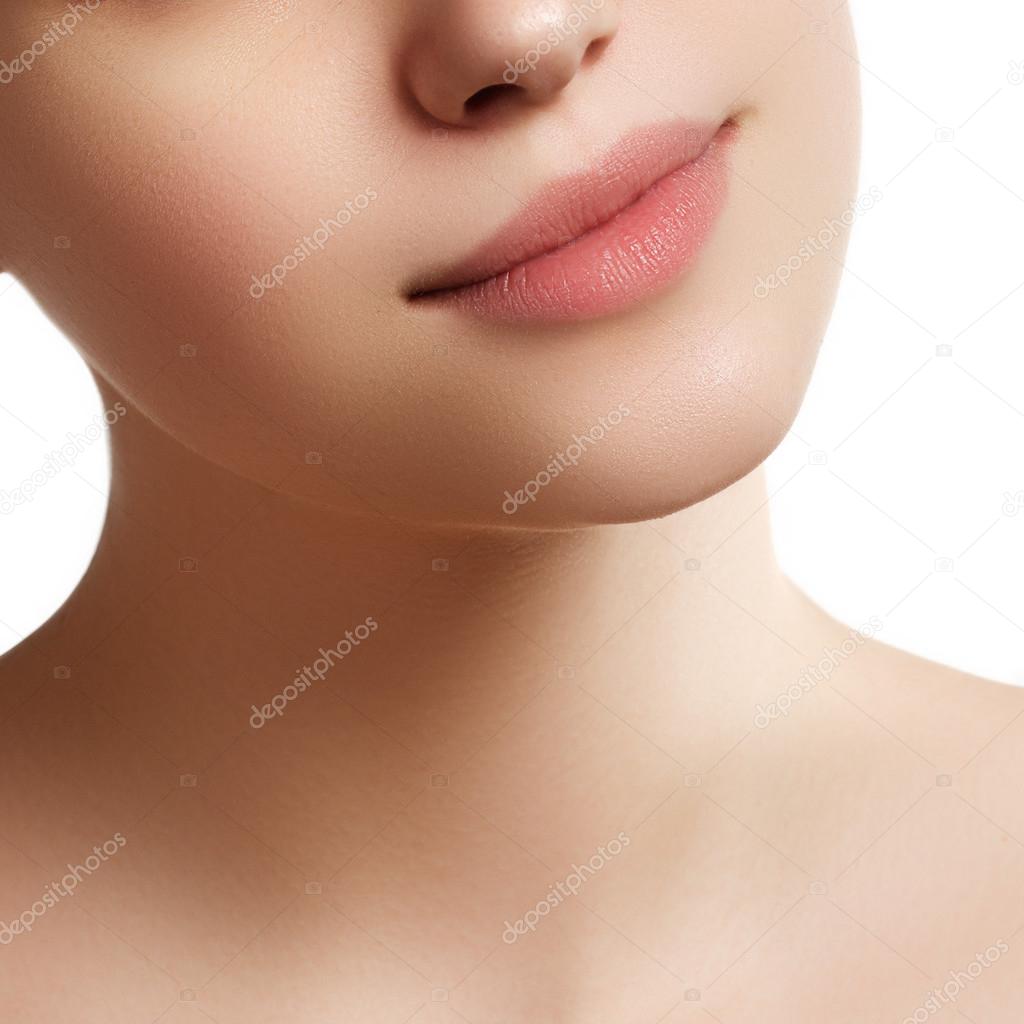 Close-up of woman's lips with fashion natural beige lipstick makeup. Perfect Lips. Sexy Girl Mouth close up. Beauty young woman Smile. Natural plump full Lip. Lips augmentation. Close up detail