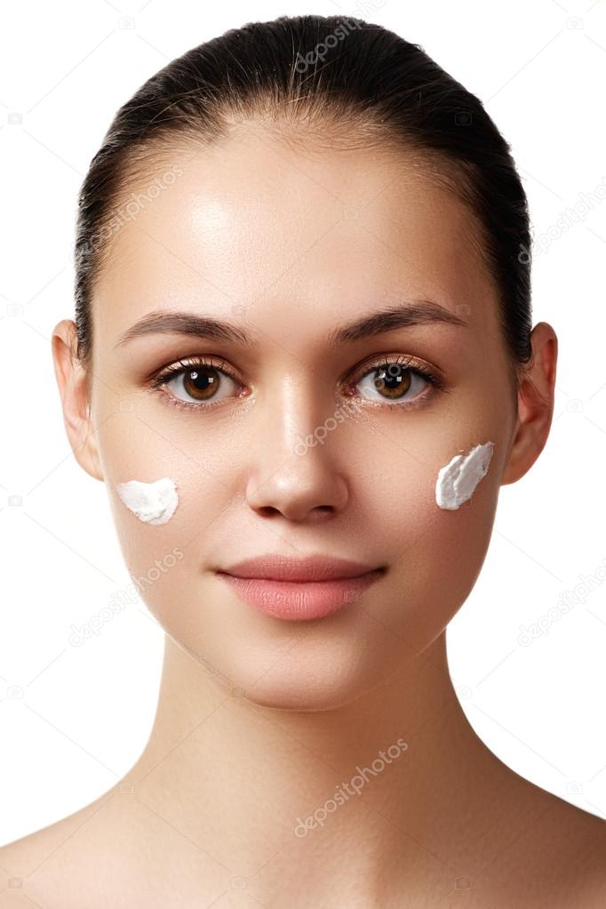 Make-up & cosmetics. Closeup portrait of beautiful woman model face with clean skin on white background. Natural skincare beauty, clean soft skin. Spa treatment