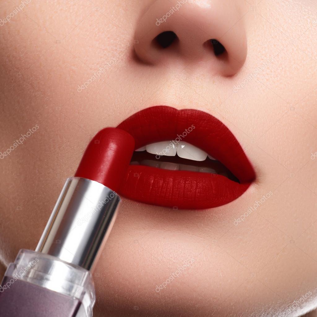 Extreme Nahaufnahme am Modell, das dunkelroten Lippenstift aufträgt.  Make-up. professionelles Retro-Make-up. dunkelroter Lippenstift. Weinlippen  – Stockfoto © looking_2_the_sky #94927318
