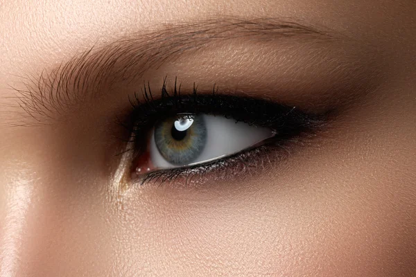 Creative eye makeup. Fashionable smoke eyes. Cosmetics and make-up. Dark eye makeup. With dark black eye makeup.