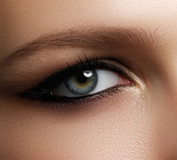 Creative eye makeup. Fashionable smoke eyes. Cosmetics and make-up. Dark eye makeup. With dark black eye makeup.