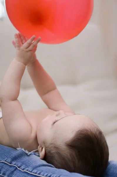 Baby playing with a red ball — Stock Photo, Image