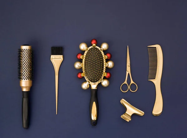 Banner de ano novo com ferramentas de cabeleireiro em ouro em um fundo azul escuro. O pente é decorado com bolas de Natal. — Fotografia de Stock