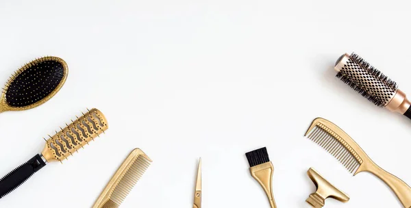 Ferramentas de cabeleireiro dourado em um fundo branco, tesoura, pente, clipe, escova. Acessórios de salão de cabeleireiro, modelo com espaço para texto — Fotografia de Stock