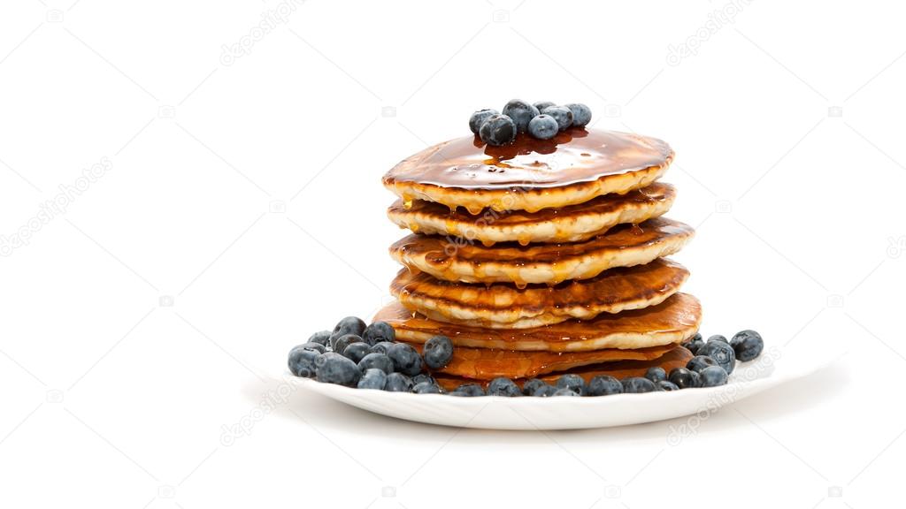 Pancakes with honey and berries on white background