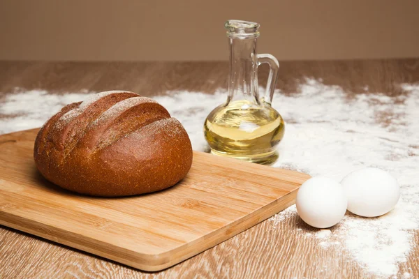 Bread on wooden table — Stock Photo, Image