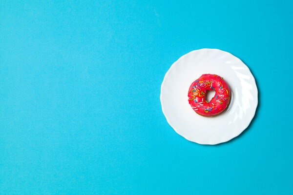 Bright donut on white plate