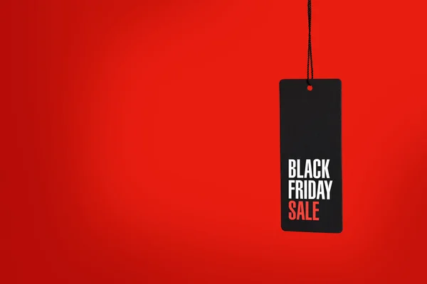 Black friday. Sale tag on red background — Stock Photo, Image