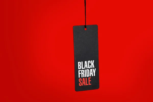 Black friday. Sale tag on red background — Stock Photo, Image