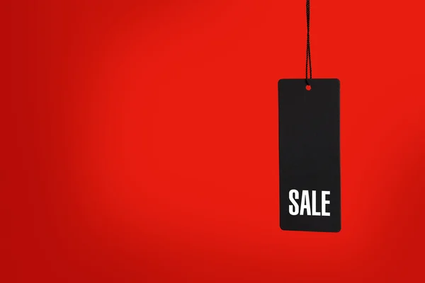 Sale tag on red background — Stock Photo, Image