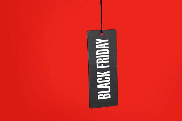 Black friday. Sale tag on red background — Stock Photo, Image