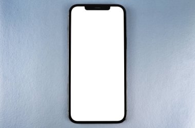 Akıllı telefon maketi iPhone 12 Pro Max, mavi arka planda beyaz ekran, üst görünümde. Apple çok uluslu bir teknoloji şirketidir. Moskova, Rusya - 15 Ocak 2021