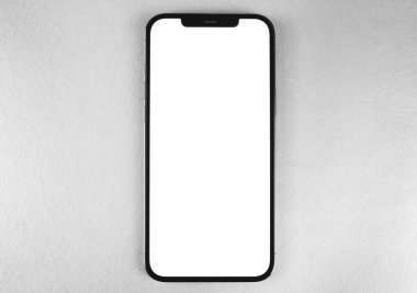 Akıllı telefon modeli iPhone 12 Pro Max, gri arka planda beyaz ekran, üst görüntü. Apple çok uluslu bir teknoloji şirketidir. Moskova, Rusya - 14 Ocak 2021