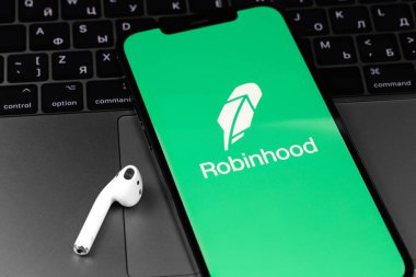 Robinhood mobile app on screen smartphone, iPhone with AirPods headphones. Robinhood Markets, Inc. - American company providing financial services. Moscow, Russia - July 13, 2021