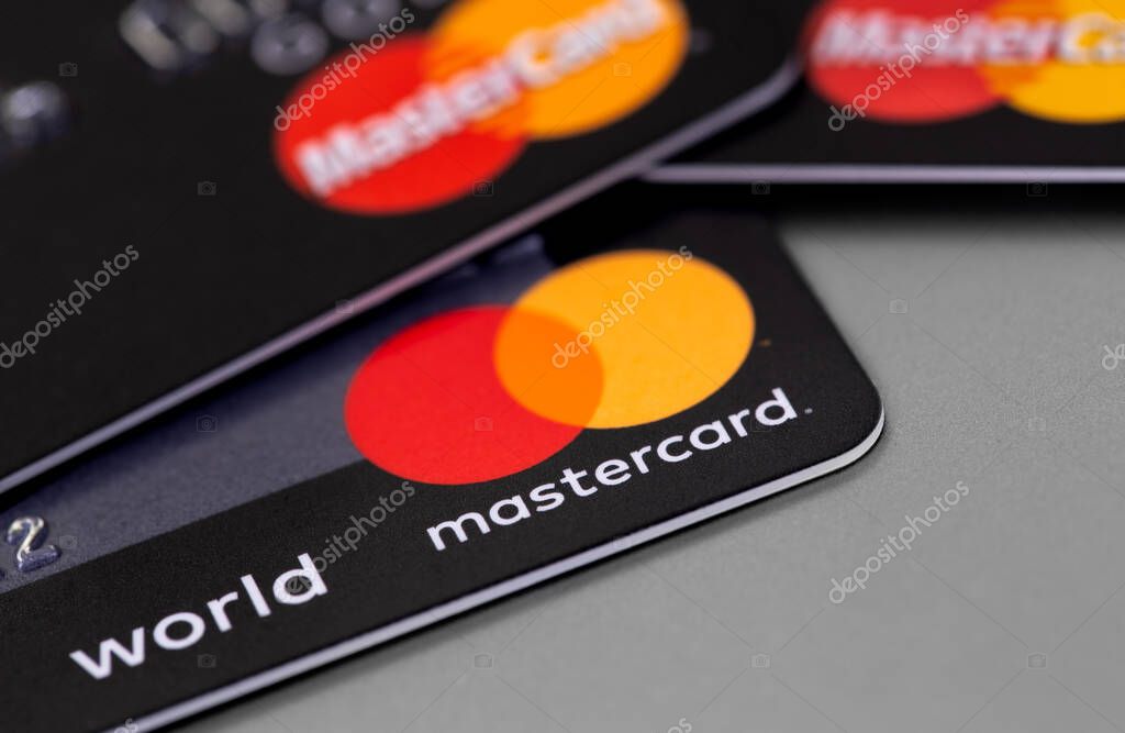 MasterCard plastic electronic, cards on grey background closeup. Master Card is international payment system. Moscow, Russia - January 18, 2021