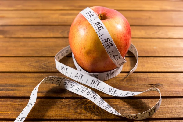 Apple with tape measure Stock Picture