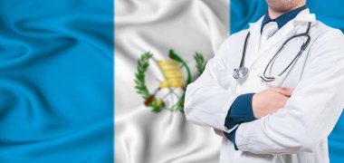 Guatemala healthcare concept. Male doctor on Guatemala flag. Doctor with crossed arms on Guatemala flag