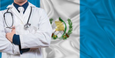 Male doctor with stethoscope on Guatemala flag. Doctor holding stethoscope on Guatemala flag