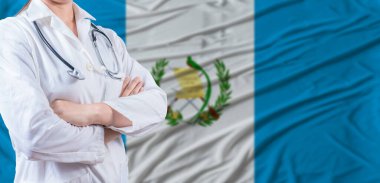 Doctor with crossed arms on Guatemala flag. Guatemala health and care concept. Female doctor on Guatemala flag