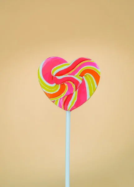 Lollipop shaped heart on a cream background — Stock Photo, Image