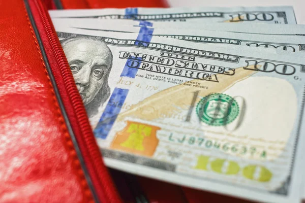 Dollar notes in a wallet, hundred-dollar bills are in a bag, Stock Photo