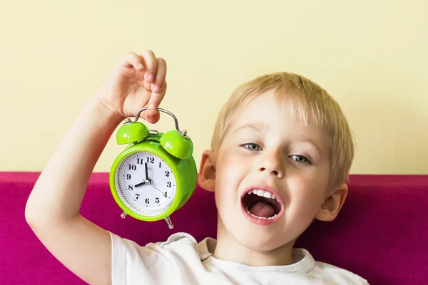 赤い目覚まし時計、赤ちゃんの目覚まし時計を持って幸せな陽気な少年 — ストック写真