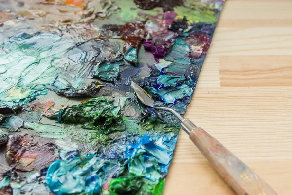 Konstnären penslar, palett kniv och palett med färger intryck — Stockfoto