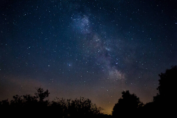 Milky Way and starry sky. Gorgeous shade of blue, purple and orange.