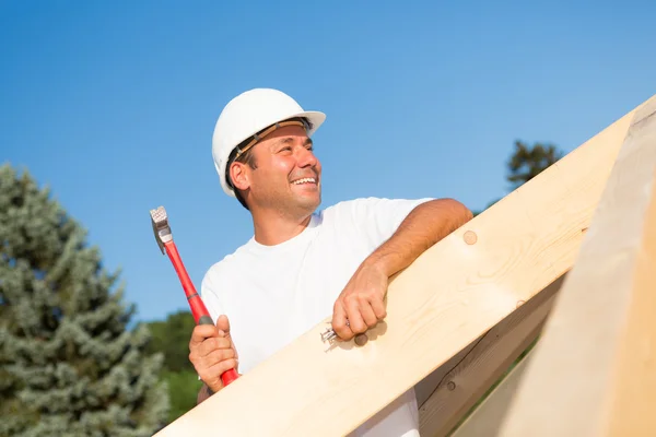 Friendly artisan working on a new house Royalty Free Stock Images