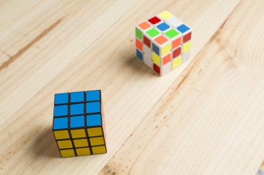 Çam ahşap arka plan üzerinde iki rubik küp.