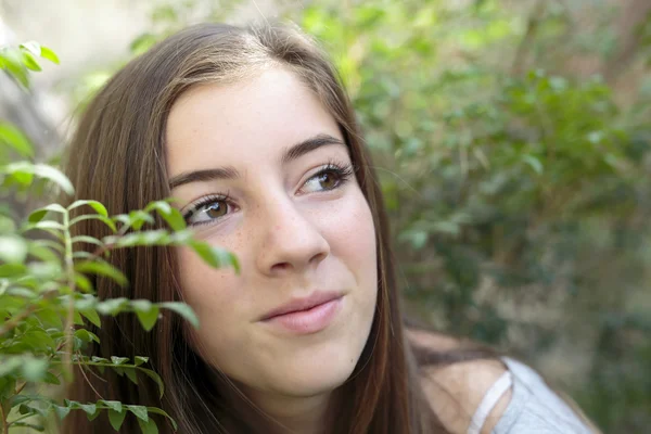 Face of a girl among branches of a tree — Stock Photo, Image