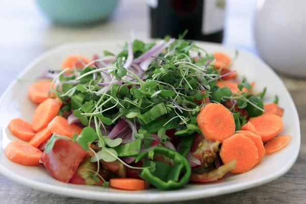 Fresh food just grown for a salad on wooden background.