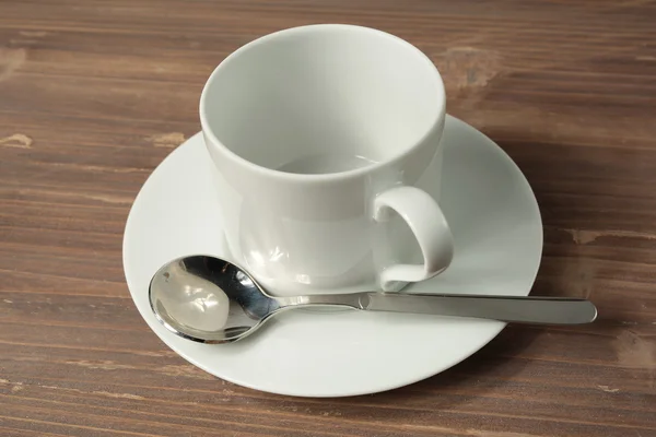 Cup and empty white plate — Stock Photo, Image