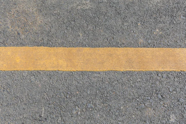 Yellow line dirty on black asphalt road texture — Stock Photo, Image