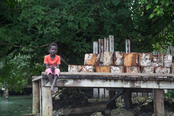 Solomon Islands, Boy sitting on a pier — Stock Photo, Image