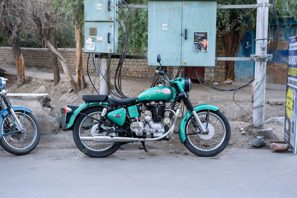 Leh, India - September 11, 2024: A Royal Enfield Bullet 350 motorbike parked on the side of a road