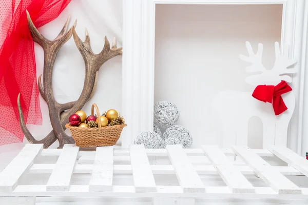 Christmas interior with a fireplace and antlers — Stock Photo, Image