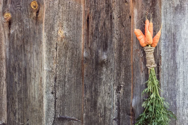 Harvest in the garden carrot on a wooden texture with space for writing — Stock Photo, Image