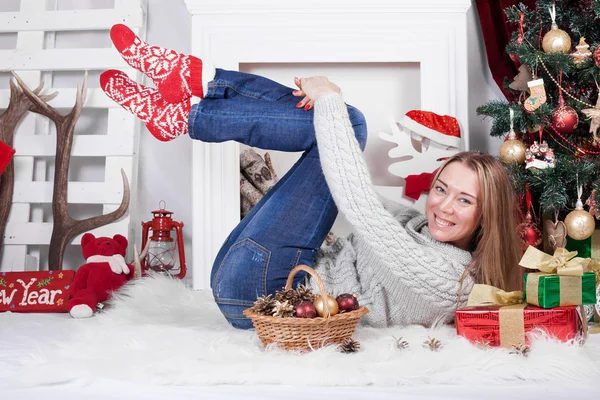 Charming girl in a Christmas interior with tree — Stock Fotó