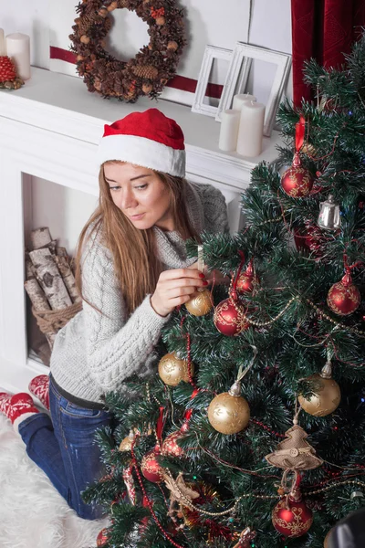 Charming girl in a Christmas interior with tree — Stock Fotó