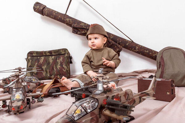 child on a white background with military toys