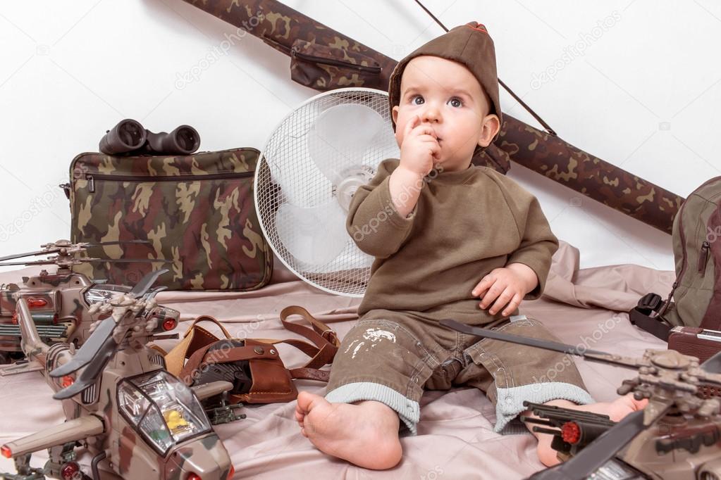 child on a white background with military toys