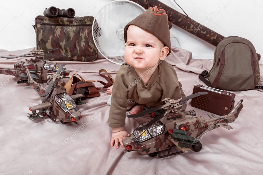 child on a white background with military toys