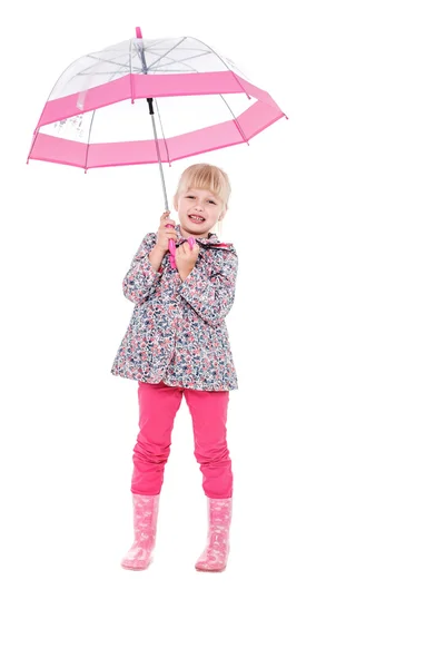 Little cute girl with an umbrella in the colorful dress isolated on white background space for inscriptions — Stock fotografie