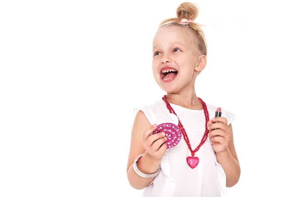 Little girl in fashionable clothes blond fashionista with a mirror and lipstick on a white space for writing — Stock Photo, Image