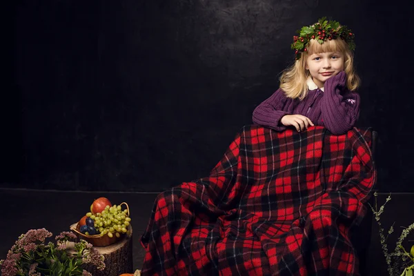Cheerful girl in the autumn interior on a dark background — Stock Image Cheerful girl in the autumn interior on a dark background Royalty Free Stock Images