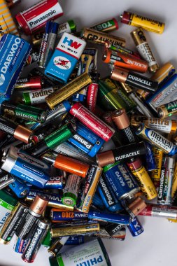 Color batteries of different sizes on a white background isolate clipart